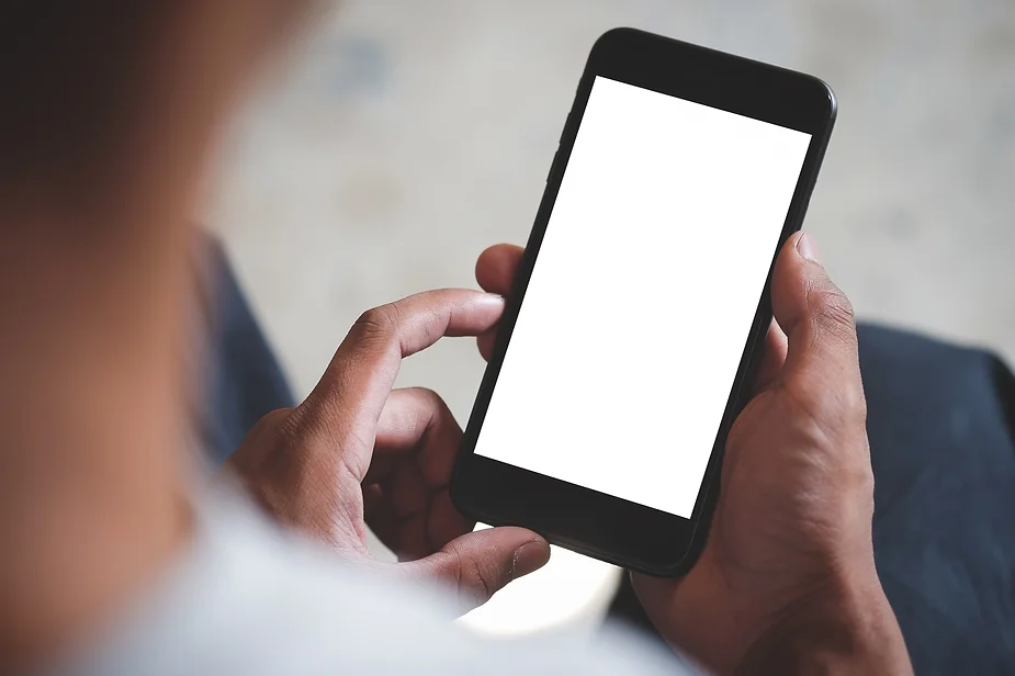 Hands holding smartphone with blank white screen