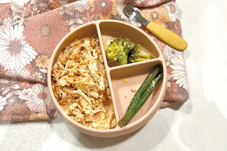 Lemony Chicken and greens in Suckie Scoop Divided Plate with baby fork and tea towel - Starting Solids Australia recipe.