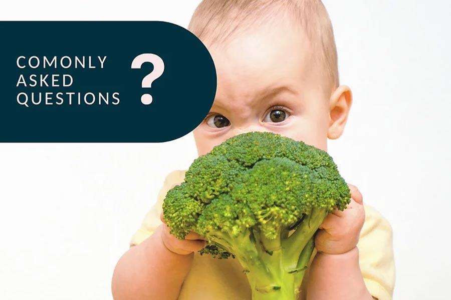 Baby eating broccoli head