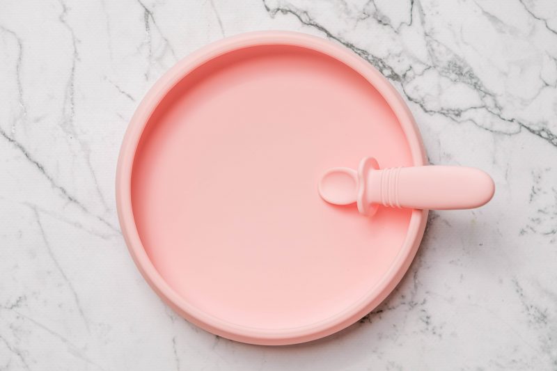 Pink Suckie Scoop Plate with Selfie Spoon by Starting Solids Australia, on a marble bench.