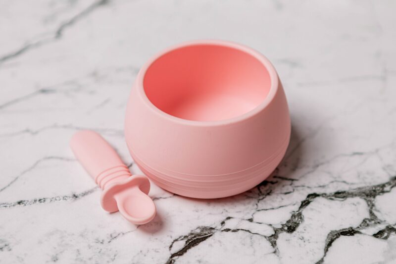 Suckie Scoop Bowl with Selfie Spoon in 'Fairy Floss' pink by Starting Solids Australia, on a marble bench.