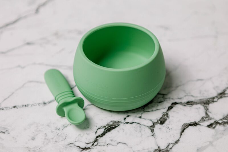 Suckie Scoop Bowl with Selfie Spoon in 'Mint Crisp' green by Starting Solids Australia, on a marble bench.