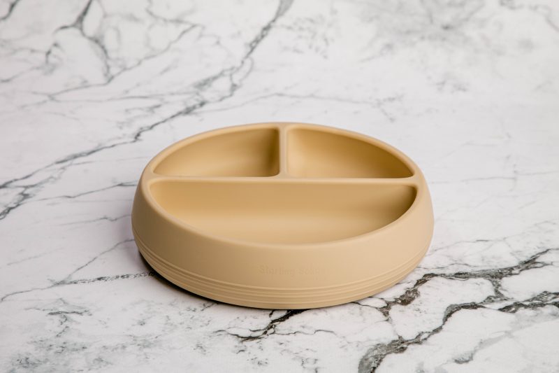 Suckie Scoop Divided Plate in 'Biscoff' yellow by Starting Solids Australia on a marble bench.