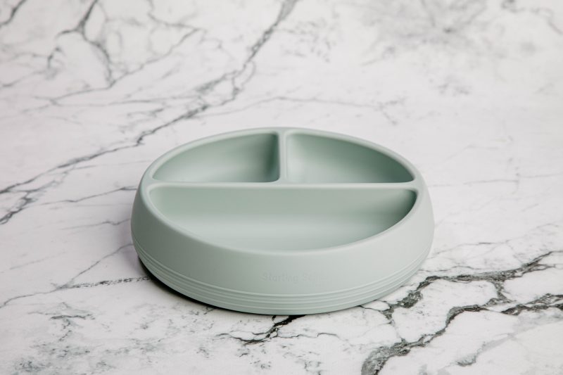 Suckie Scoop Divided Plate in 'Meringue' grey by Starting Solids Australia on a marble bench.