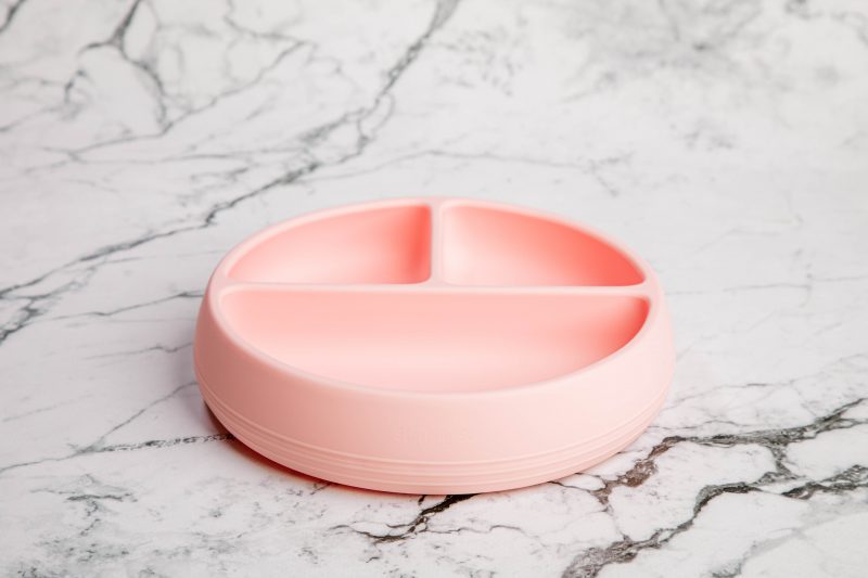 Suckie Scoop Divided Plate in 'Fairy Floss' pink by Starting Solids Australia on a marble bench.