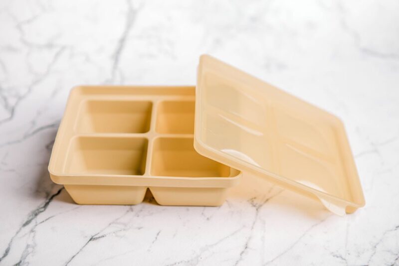 'Biscoff' yellow Freezie Tray by Starting Solids Australia on a marble bench.