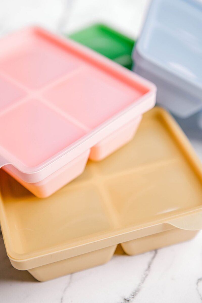 An assortment of coloured Freezie Trays by Starting Solids Australia on a marble bench.