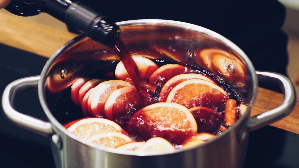 silver stock pot with liquid substance and lemon