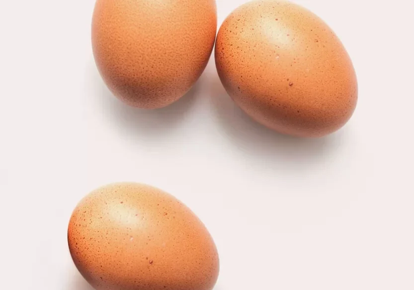 Three chicken eggs on a white background