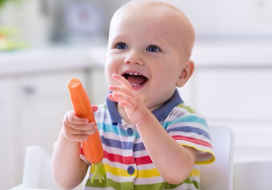 Baby eating a carrot as a resistive food teether by Starting Solids Australia