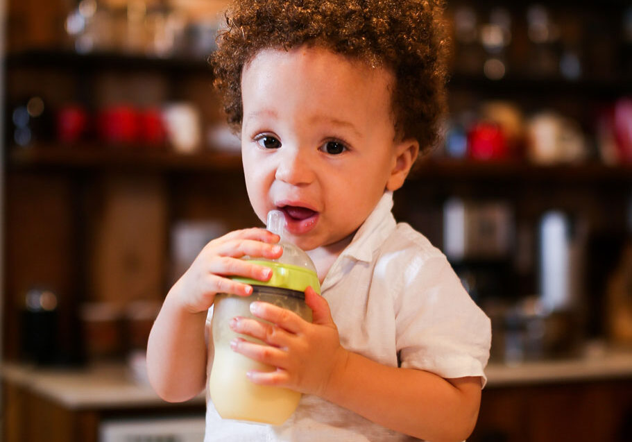 Toddler drinking milk out of a bottle