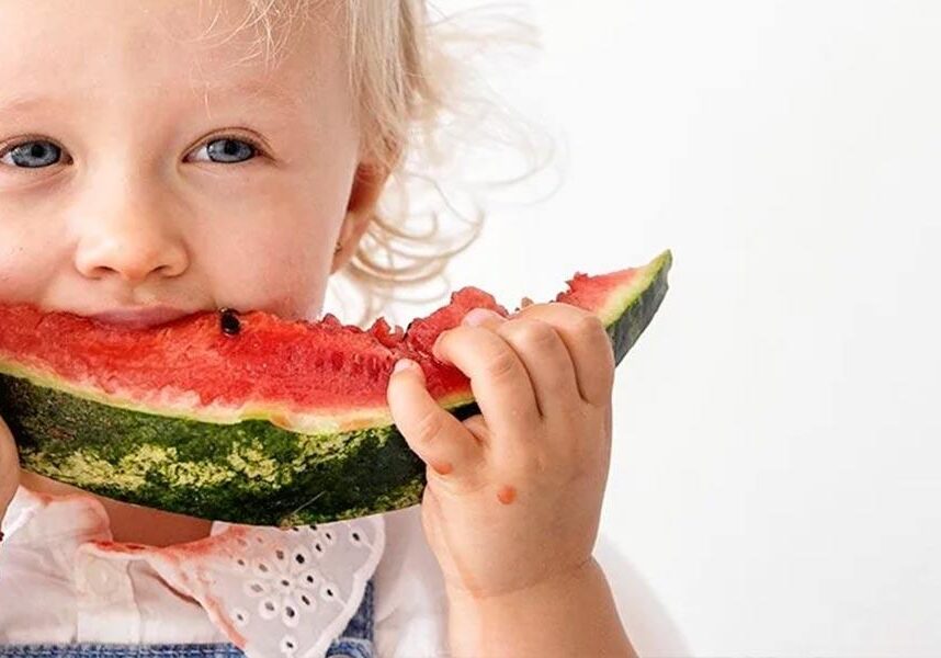 Toddler eating watermelon