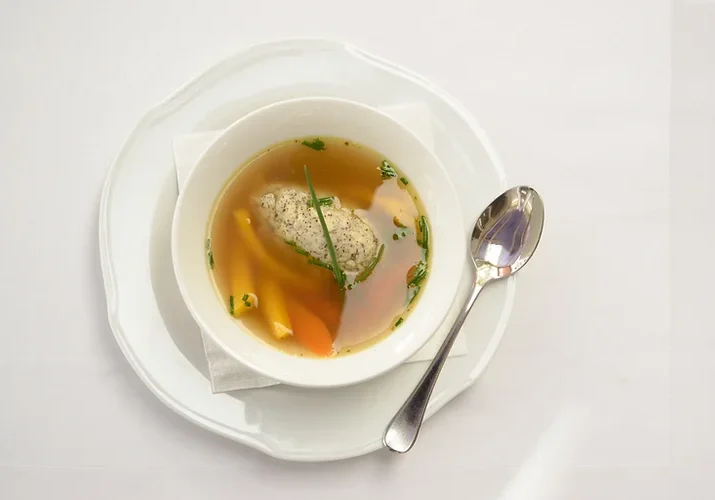 Bone broth in bowl with spoon.