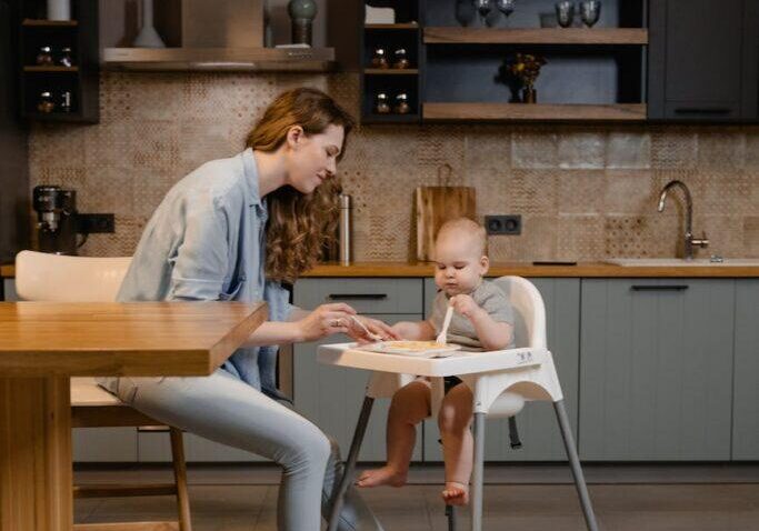 a woman feeding a child