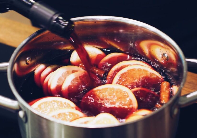 silver stock pot with liquid substance and lemon